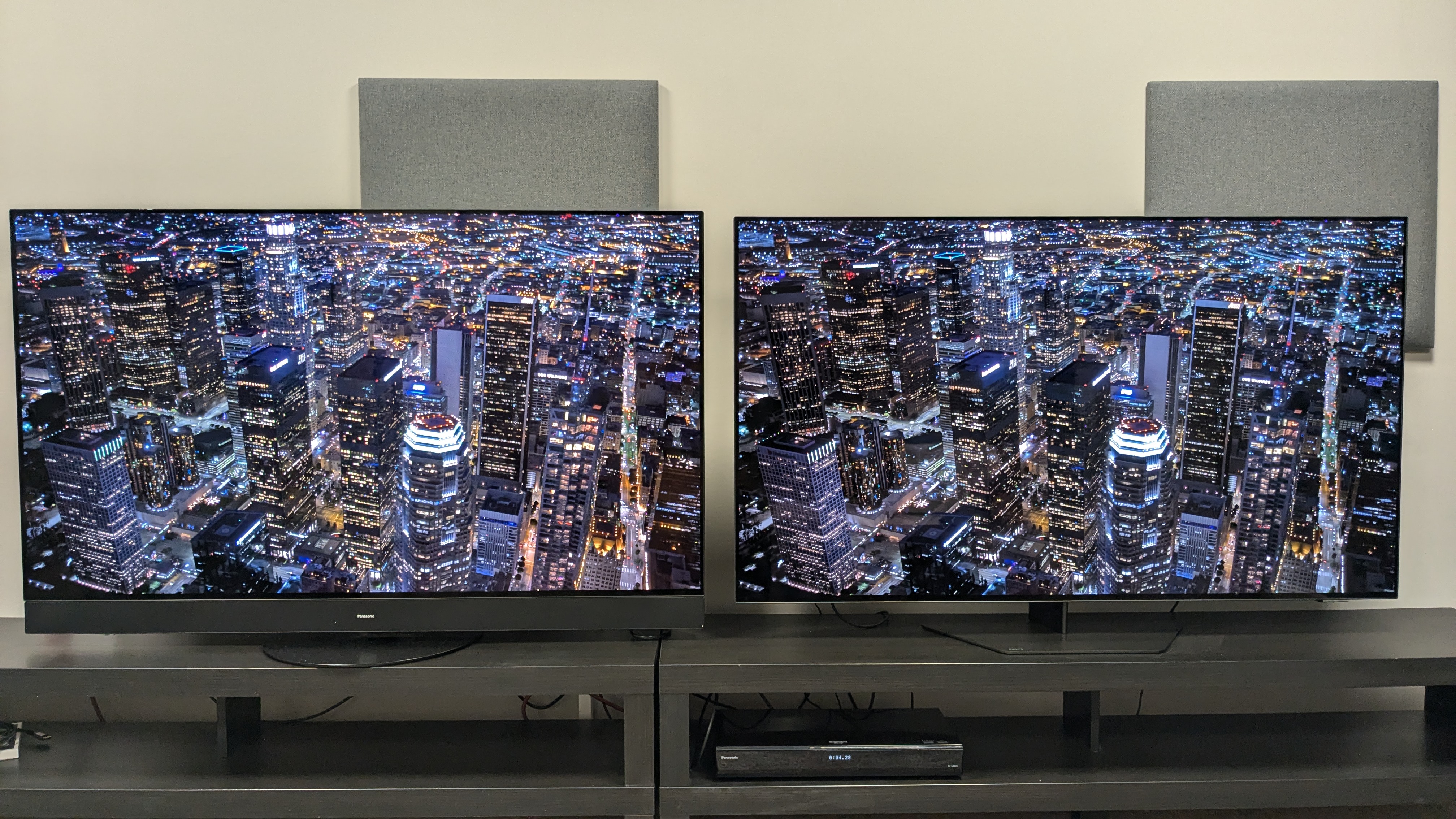 Panasonic MZ1500 and Philips OLED809 with aerial city shot at night on screen 